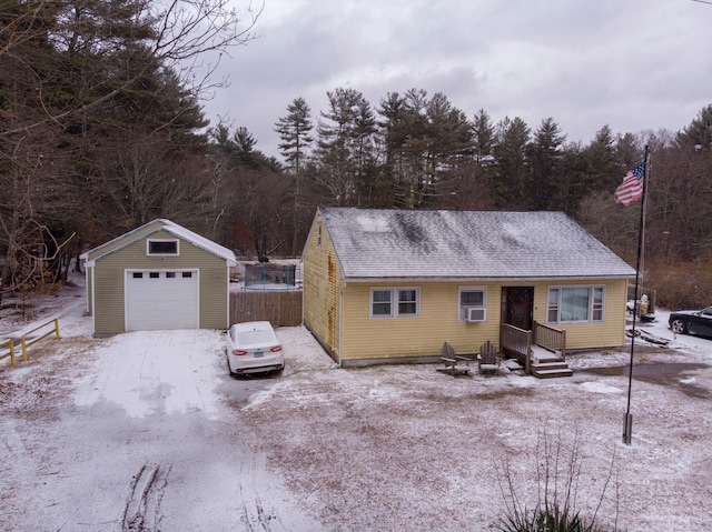 ranch-style house featuring an outbuilding, a garage, and cooling unit