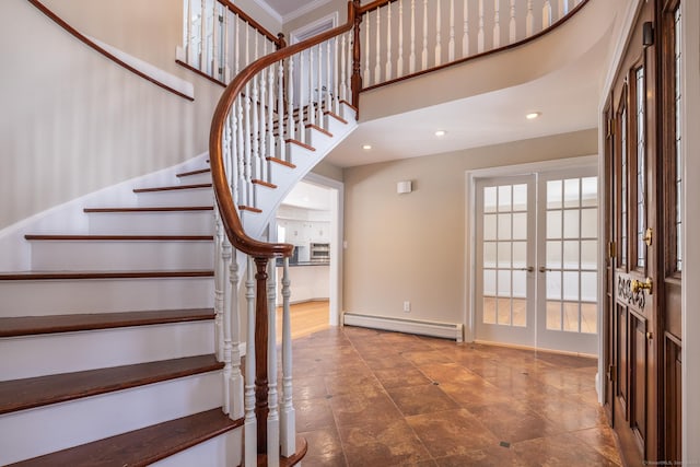 entrance foyer featuring a baseboard heating unit, recessed lighting, french doors, and a towering ceiling