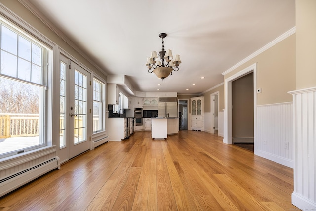 16 Saddle Ridge Rd, New Milford, CT 06776 - kitchen with baseboard heating, dark countertops, a notable chandelier, and crown molding
