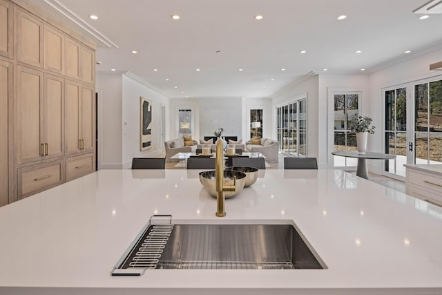 kitchen featuring crown molding, french doors, and light brown cabinets