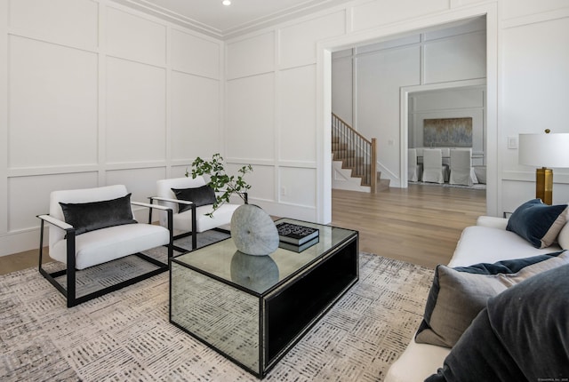 living room featuring ornamental molding and light wood-type flooring