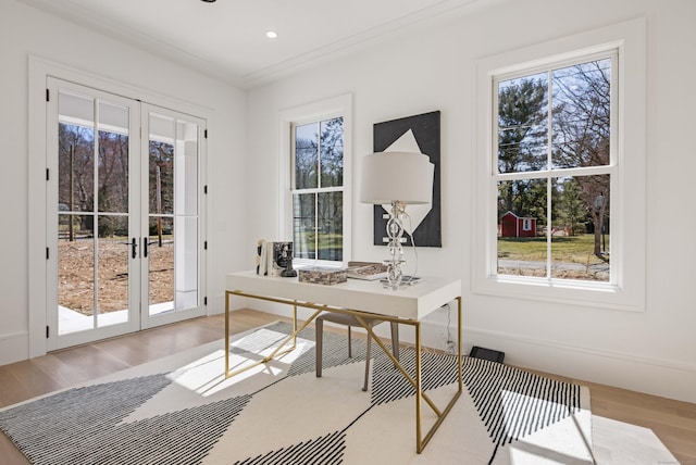 office space featuring french doors, ornamental molding, and light hardwood / wood-style flooring