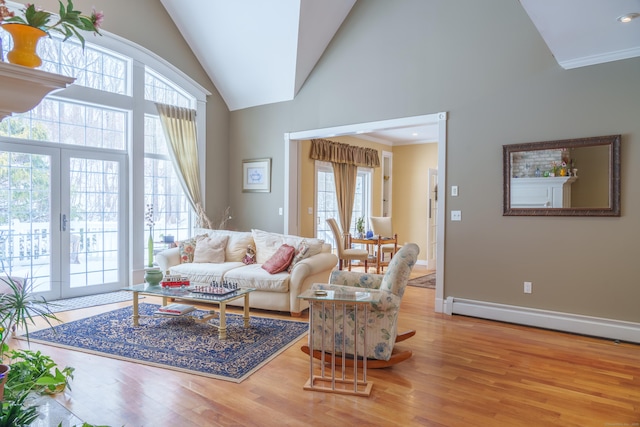 living room with hardwood / wood-style flooring, a baseboard heating unit, high vaulted ceiling, and french doors