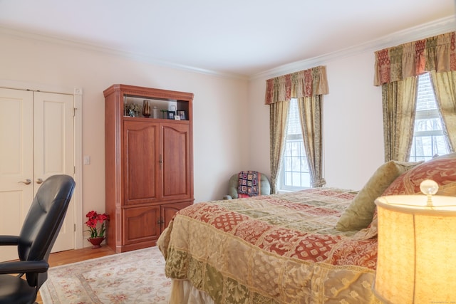 bedroom featuring light hardwood / wood-style flooring and ornamental molding