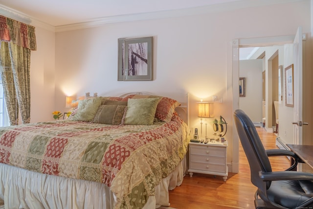 bedroom with crown molding and light hardwood / wood-style flooring