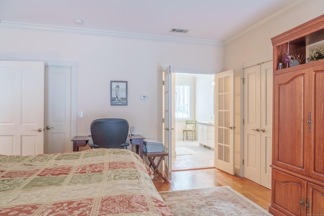 bedroom with french doors, ornamental molding, and light hardwood / wood-style flooring