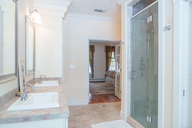 bathroom featuring a shower with door, crown molding, and a baseboard radiator