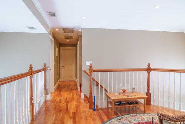 corridor featuring light hardwood / wood-style flooring and ornamental molding