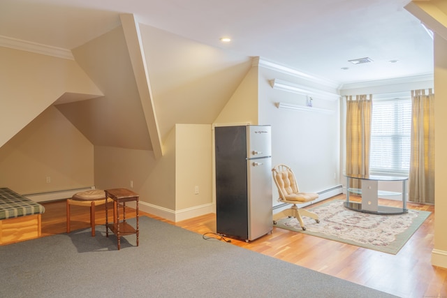 interior space featuring stainless steel fridge, ornamental molding, a baseboard radiator, and light wood-type flooring