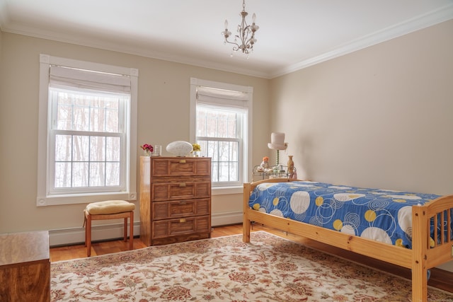 bedroom featuring a baseboard radiator, hardwood / wood-style floors, a notable chandelier, and crown molding