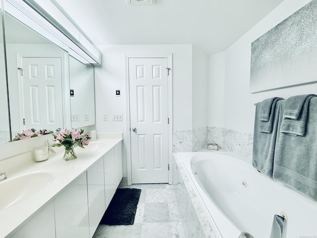 bathroom featuring vanity and tiled tub