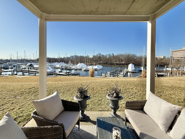 view of patio with a water view and a dock