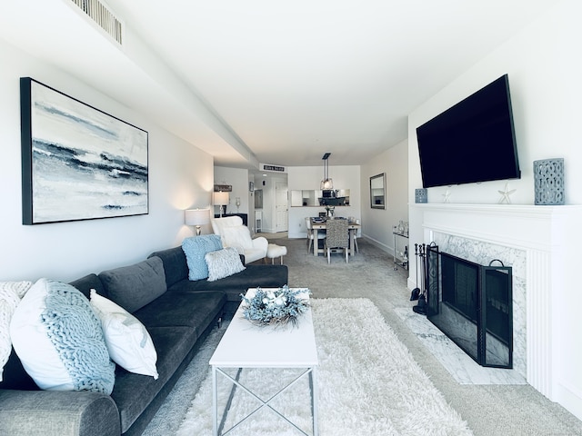 living room with carpet flooring and a fireplace