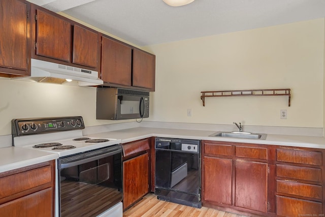 kitchen with light hardwood / wood-style floors, sink, and black appliances