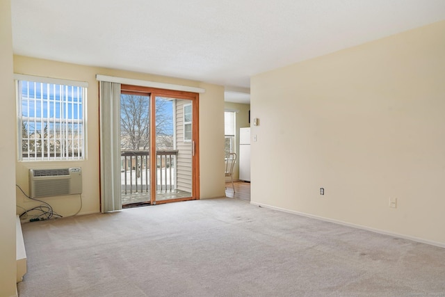 carpeted spare room with a textured ceiling and a wall mounted AC