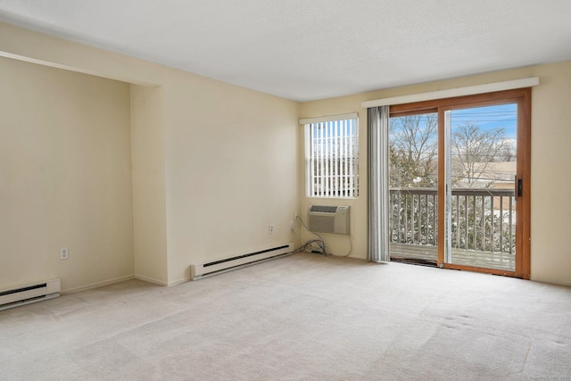 carpeted spare room with a baseboard radiator, a wall unit AC, and a textured ceiling