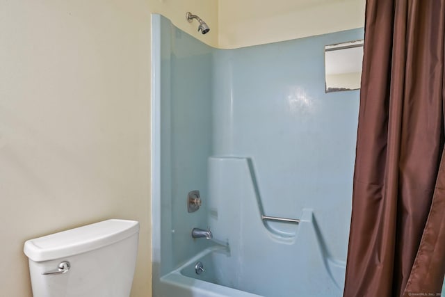 bathroom with shower / bath combination with curtain and toilet