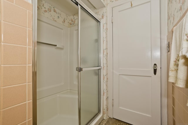 bathroom with a shower with door