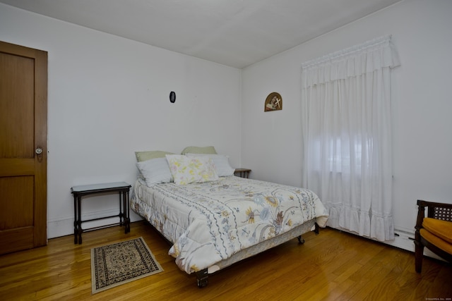 bedroom with hardwood / wood-style floors