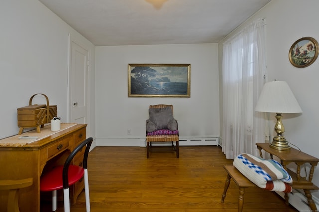 living area featuring hardwood / wood-style flooring and a baseboard radiator