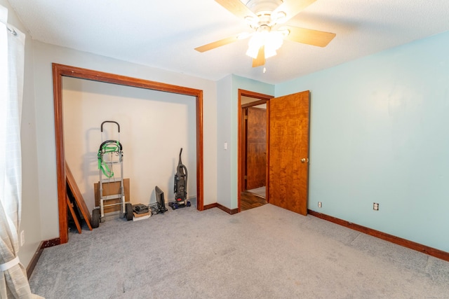 spare room featuring ceiling fan and light carpet