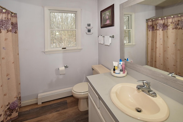 bathroom featuring hardwood / wood-style flooring, vanity, toilet, and a baseboard heating unit