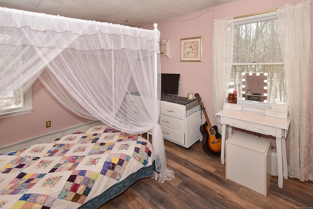 bedroom with dark hardwood / wood-style flooring