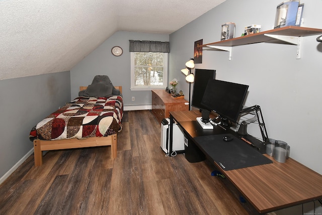 bedroom featuring dark hardwood / wood-style flooring, a baseboard heating unit, vaulted ceiling, and a textured ceiling