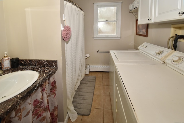 washroom featuring sink, independent washer and dryer, and light tile patterned flooring