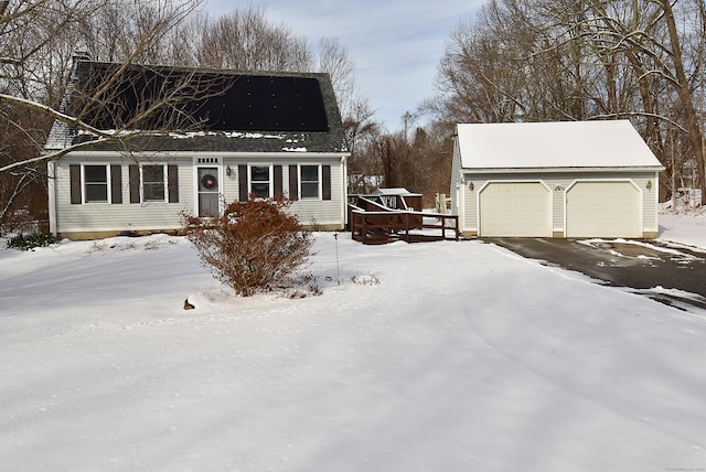 snow covered property with a garage