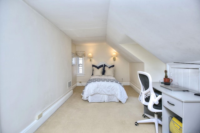 carpeted bedroom featuring lofted ceiling, visible vents, and baseboards