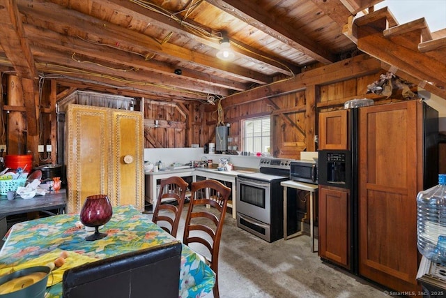 kitchen with wooden walls and appliances with stainless steel finishes