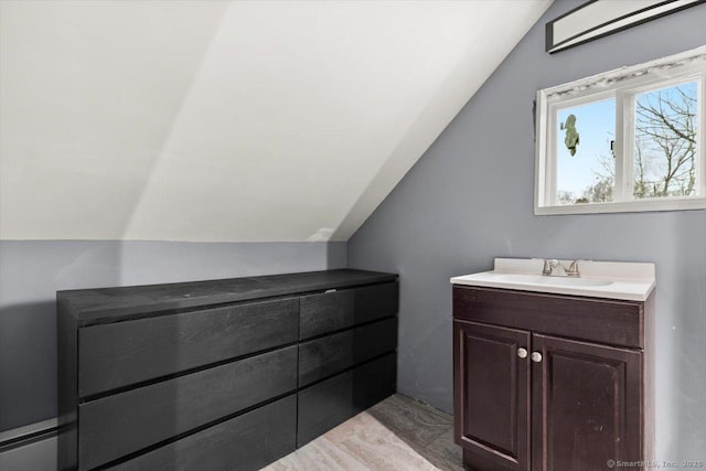 bathroom with lofted ceiling and vanity