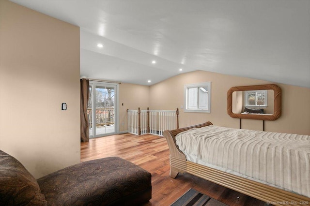 bedroom featuring hardwood / wood-style flooring, vaulted ceiling, and access to outside