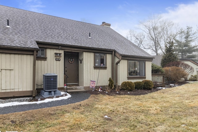 view of front of home featuring a front yard and central air condition unit