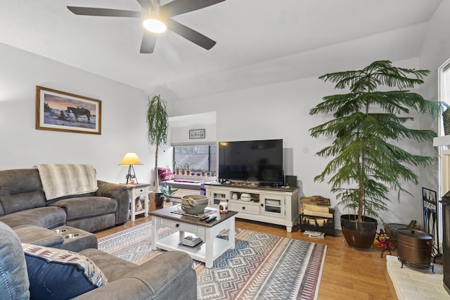 living room featuring ceiling fan, a wealth of natural light, and light wood-type flooring