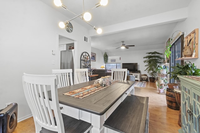 dining room featuring ceiling fan, beam ceiling, and light hardwood / wood-style floors