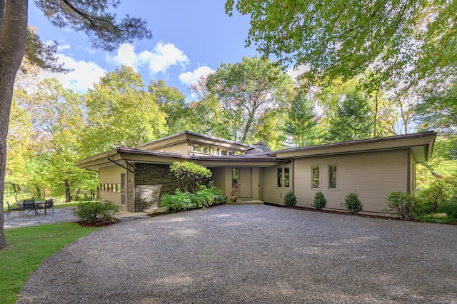 prairie-style house with a garage and a patio area