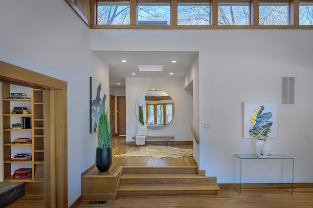 foyer featuring hardwood / wood-style flooring and a high ceiling