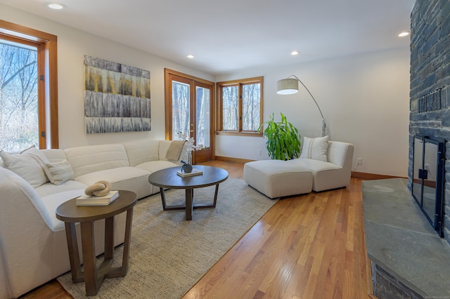 living room with a large fireplace and light hardwood / wood-style floors