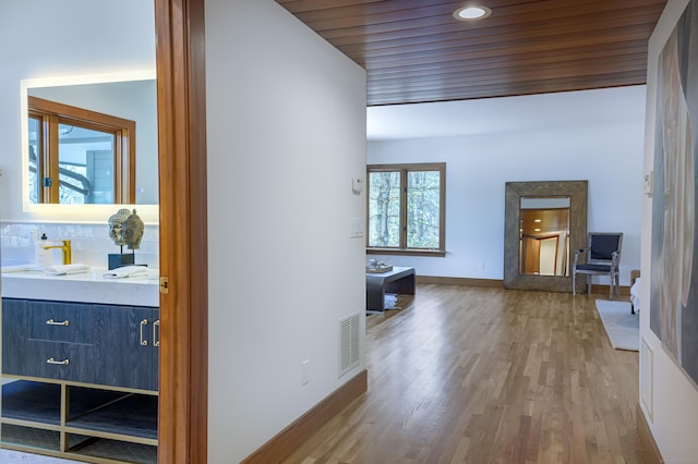 hall with hardwood / wood-style floors and wooden ceiling