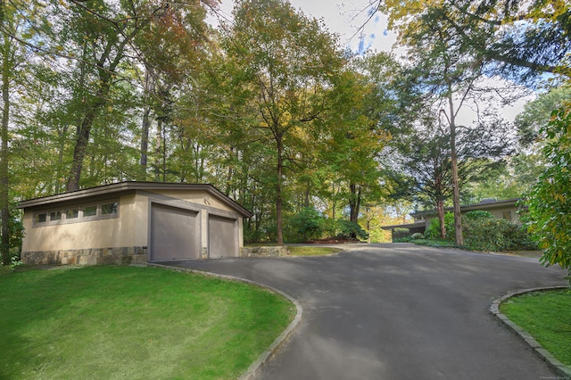 view of front facade with a garage and a front lawn