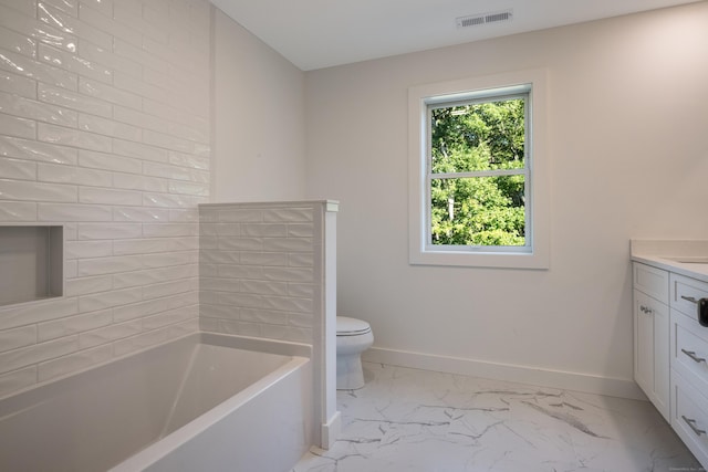 bathroom featuring vanity, a bath, and toilet