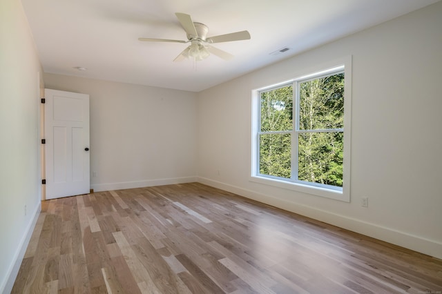 empty room with ceiling fan and light wood-type flooring