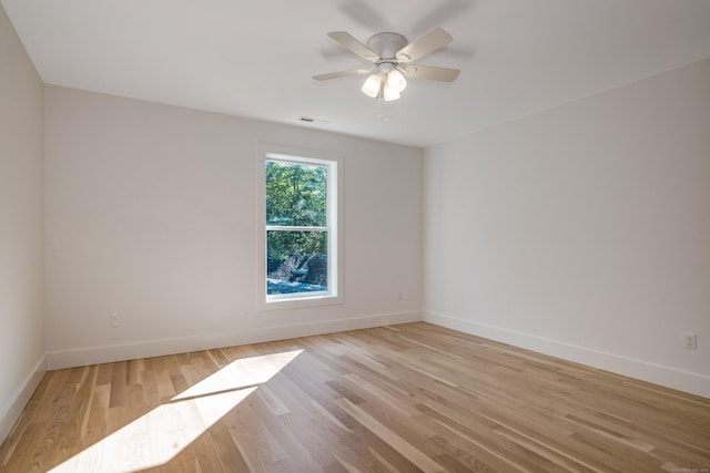 spare room with ceiling fan and light wood-type flooring