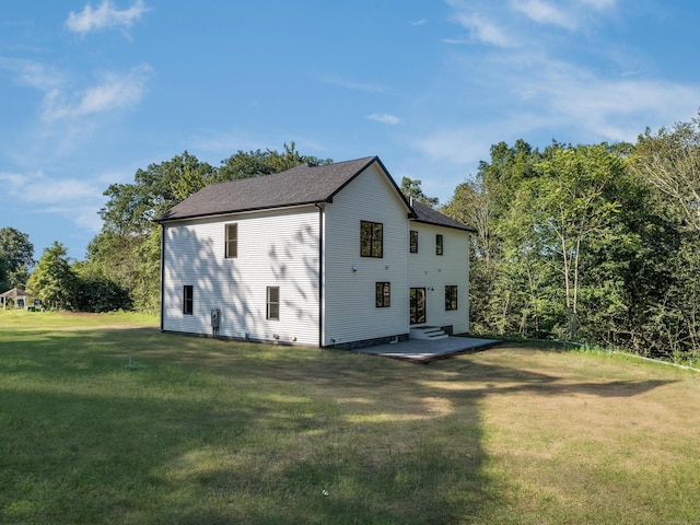 back of property featuring a yard