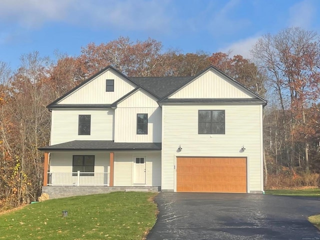 view of front of property with a garage and a front lawn