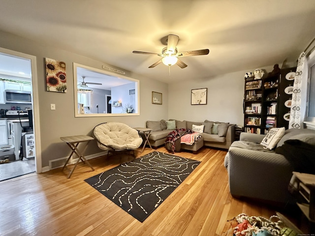 living room featuring hardwood / wood-style floors and ceiling fan