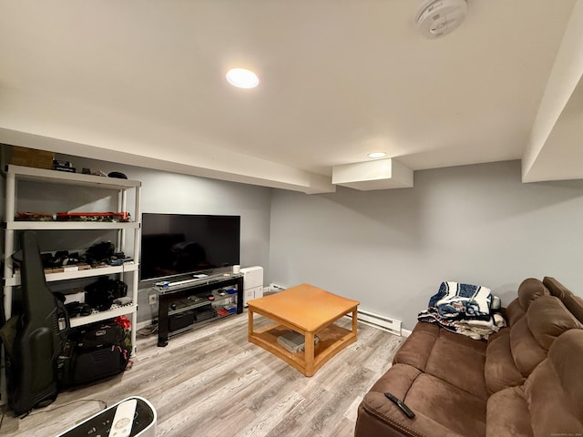 living room featuring a baseboard radiator and light wood-type flooring