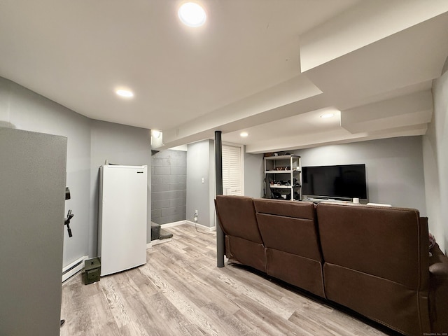 living room with light hardwood / wood-style floors and baseboard heating